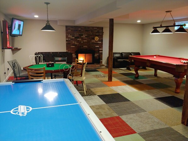 game room: flatscreen TV, fireplace, foosball, pool, poker, airhockey, boss toss