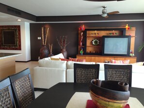 Living room/ dining area and entertainment center.