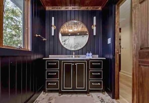 [Primary Bathroom] The Master Bathroom is Styled with Exquisite Finishing Touches and a Sleek Design Perfect for Relaxation After a Fun Day on the Lake. 