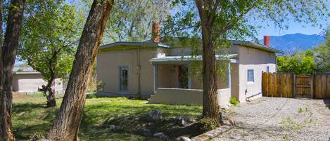 Front of main house with acequia (irrigation canal)