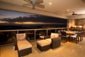 The large lanai includes lounge seating along with a dining area for 8 guests.