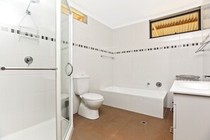 Main bathroom with bath, shower and toilet