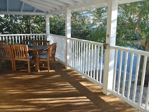 Wrap around porch with seating for 6 at table and 2 more on wooden swing