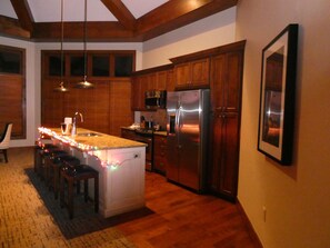 Kitchen area with chairs to dine at counter.