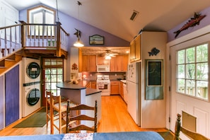 Dining area view of kitchen and side door to porch with dog door