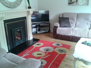 Large comfy sitting room with large 3 seater settee and 2 armchairs