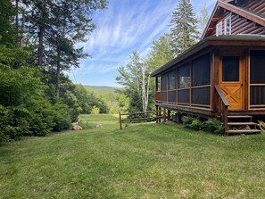 Cabin view of field and ridge line. Screened porch.