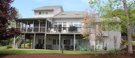 Back of Oasis.  Screened porch with seating and seating on bottom floor as well