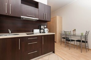 Living area with kitchenette, capacious wardrobe, dining area and comfortable double bed.