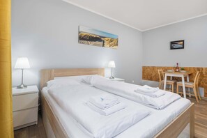 Functional and atmospheric living area with comfortable double bed and dining space.