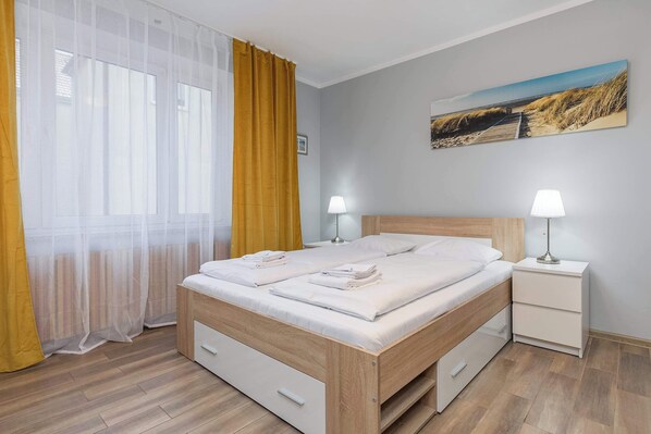 Cosy, wooden living area with comfortable bed and functional cabinets, where the guests can store their handy trinkets.