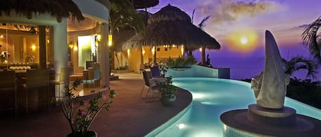 VIEW ACROSS POOL TO LIVING ROOM AND PALAPA BAR