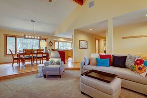 Light and bright living room opens to dining area and kitchen.