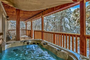 Enjoy the forested views from this large backyard hot tub