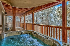 Enjoy the forested views from this large backyard hot tub