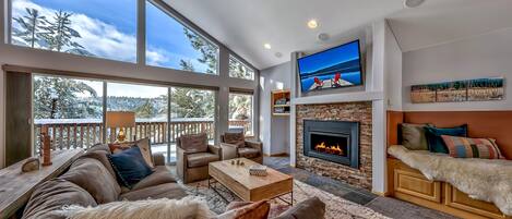 Immediately, you'll feel right at home in this grand, open livin - Immediately, you'll feel right at home in this grand, open living space with a fireplace, TV with AV system, and plenty of seating. Not to mention that view!