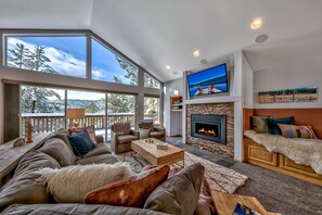 Immediately, you'll feel right at home in this grand, open livin - Immediately, you'll feel right at home in this grand, open living space with a fireplace, TV with AV system, and plenty of seating. Not to mention that view!