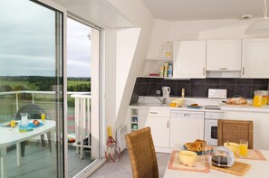 Prepare meals in the kitchenette and enjoy them at the dining table.