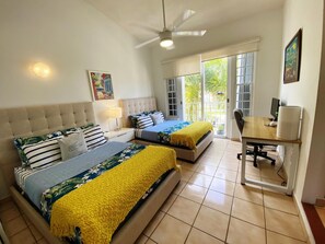 Enjoy this cozy bedroom equipped with two comfortable beds and a desk