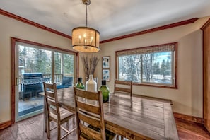 Dining area opens to balcony with large gas BBQ, cozy living room and  gourmet kitchen