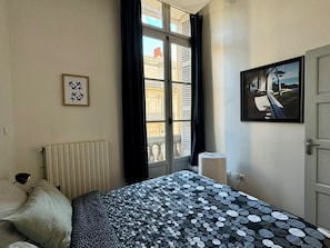 The bedroom has a Juliet balcony and air conditioning. 