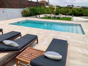 View of the pool and gardens from the lounge