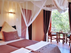 the 2nd bedroom with two twin beds and mosquito net above the bed. 