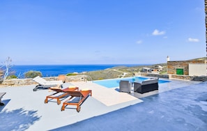 The terrace, pool area, sea view and sunbeds