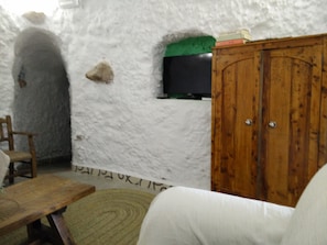 Partial view of the living room. At the back hallway to the bedroom.