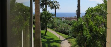 View over the gardens to the Mediterranean .