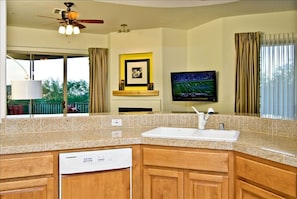 Looking out to living room.  Watch tv while cooking.