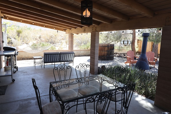 Enjoy a meal at the table under the shady covered outdoor patio.