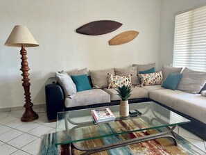 Living room. Kitchen to the left. Ocean view to the right.