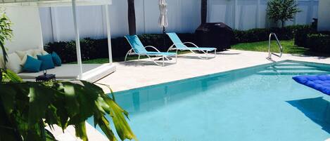 Relax in your private pool with lounge chairs and king-sized South Beach sunbed