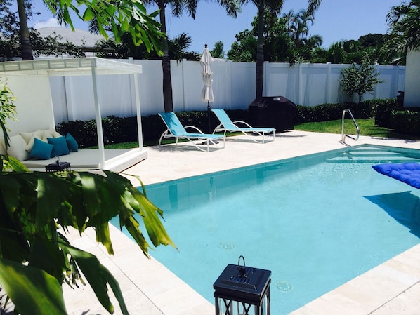 Relax in your private pool with lounge chairs and king-sized South Beach sunbed