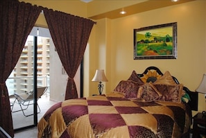 Guest room with California King and door to balcony.