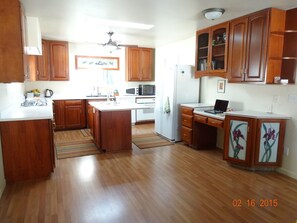 Kitchen area with new stove, sinks, counter tops.