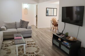 Relax on the new linen couch and love seat in front of the smart TV.