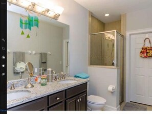master bath with double vanity and walk in closet