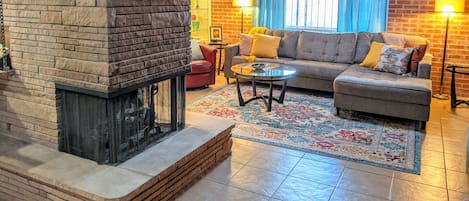 3-sided fireplace separates the living room from dining/kitchen