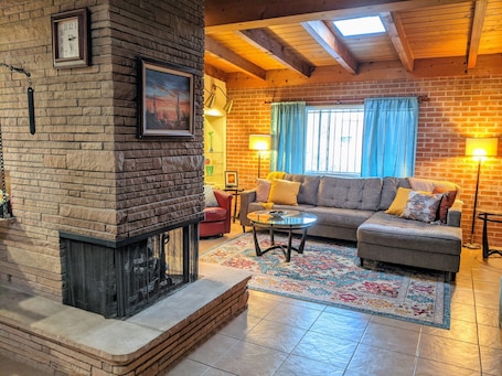 3-sided fireplace separates the living room from dining/kitchen