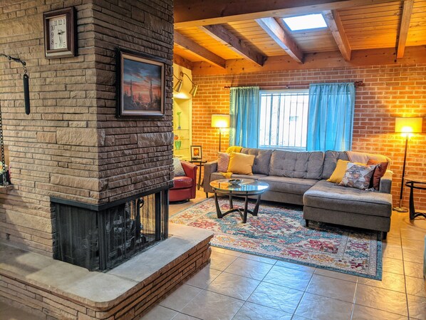 3-sided fireplace separates the living room from dining/kitchen