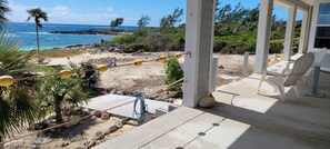 The view across the backyard to the rocky point  from the back covered patio. 