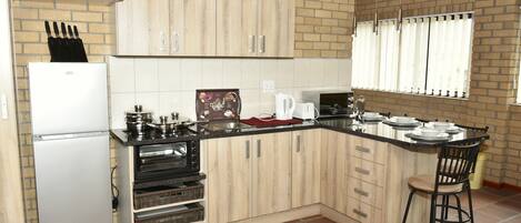 The kitchennete is fully equipped with crockery and cooking utensils.