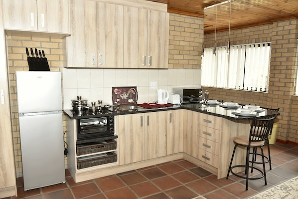 The kitchennete is fully equipped with crockery and cooking utensils.