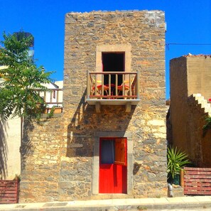 Front of windmill with two balconies. The large garden is at the back.