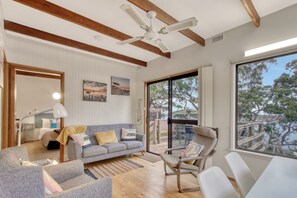 Cosy living area with pops of warms colours to brighten any day