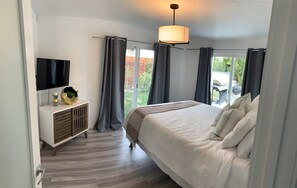 Guest bedroom with two sliding doors out to the fabulous and private yard.