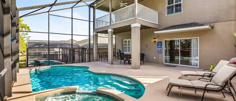Large fully screened in pool area with relaxing pool and spa