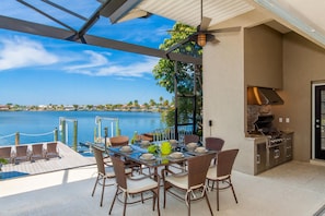 Southern Comfort Lanai with outside kitchen and dining area overlooking the Lake with  Gulf access